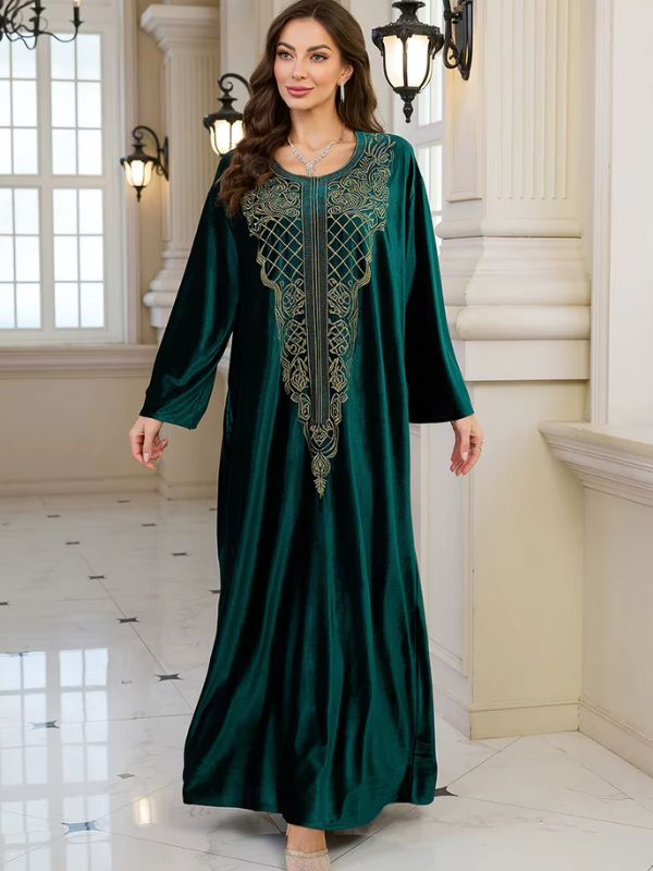 Abaya Dubaï en velours vert bouteille, vue de face, bras le long du corps, robe ample jusqu'au sol et plastron brodé doré
