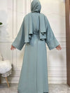 Femme de dos porte une abaya kimono dubai de couleur bleu azur