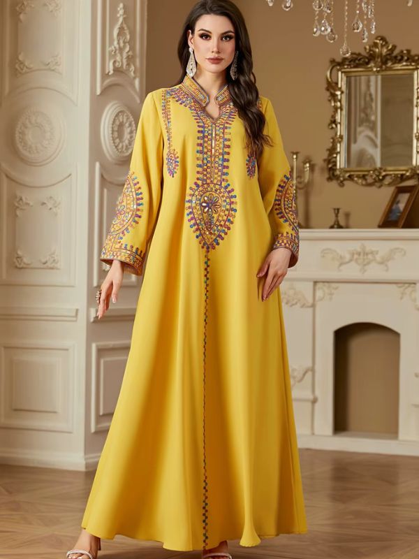 Une femme qui se tient dans un intérieur luxueux et qui porte une abaya