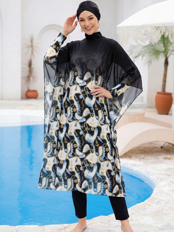 Burkini hijab noir à décor d'ancres crème et dorées, manches cape en voile noir, bonnet-turban noir, main levée