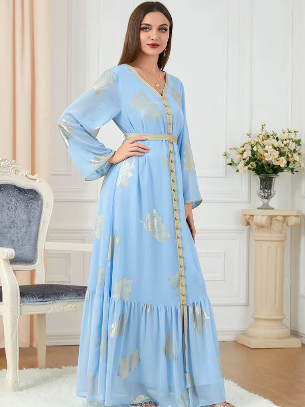 Une femme porte un caftan algérien bleu ciel décoré de motifs dorés
