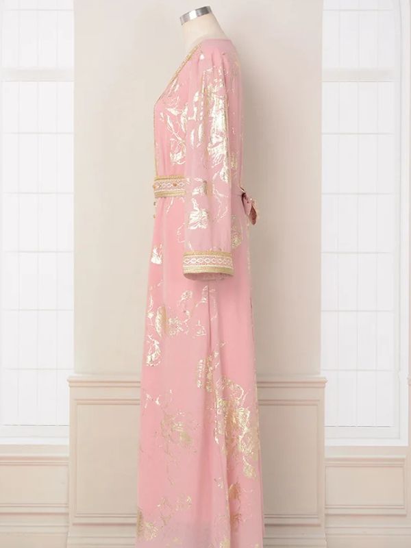 Vue frontale d’un caftan marocain rose et doré, à manches longues et ceinture assortie