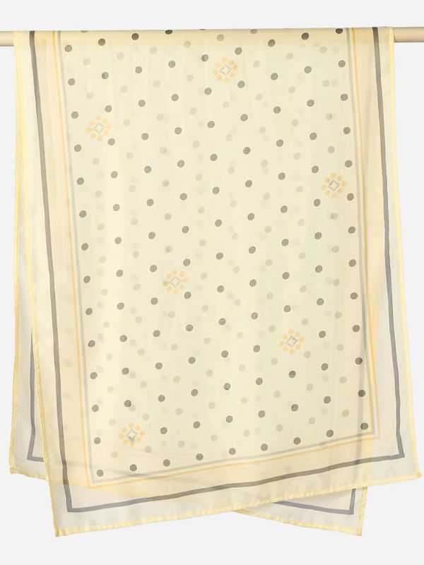 Hijab en coton imprimé jaune vanille, suspendu à une barre, pois gris et petits motifs jaune orangé, double liseré gris et jaune