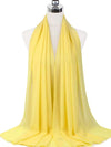 Un hijab en mousseline jaune pastel drapé sur un mannequin