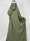 Une femme porte un long jilbab vert olive