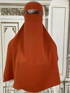 niqab orange qui est afficher en exposition sur mannequin